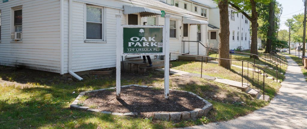 The Oak Park sign sits at the corner and features the Equal Housing Opportunity logo and reads Oak Place, 129 Ursula Place.